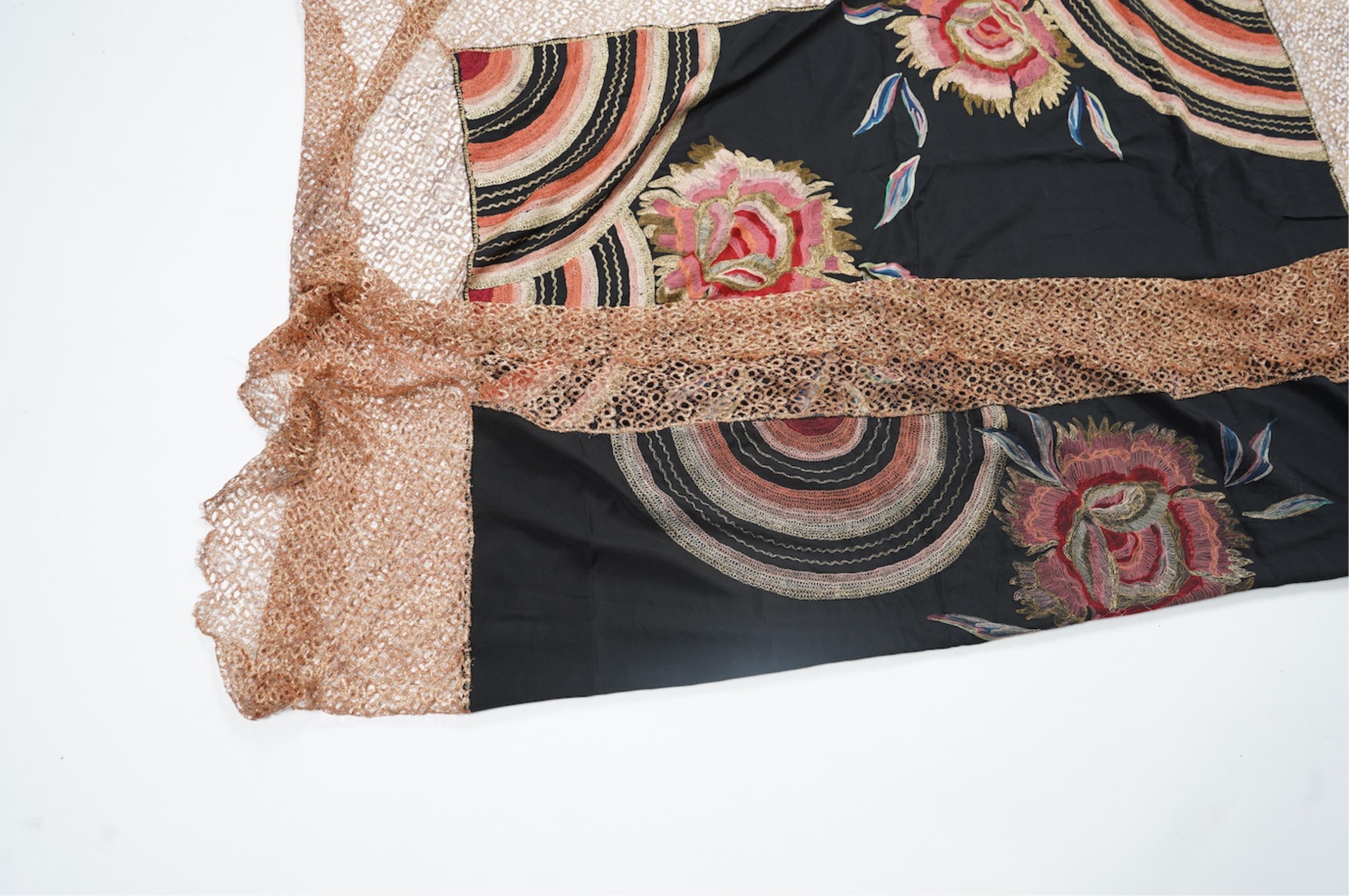 An Art Deco black silk floral embroidered shawl, using tones of red and orange with gold highlights, bordered with bronze metallic lace, together with a black crepe and yellow silk embroidered stole. Art Deco stole, 142c
